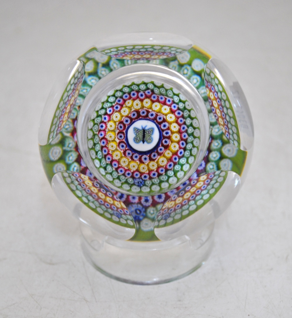 A faceted glass paperweight decorated with a central butterfly cane and concentric bands of canes in - Image 4 of 8