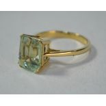 A rectangular synthetic quartz ring, 9ct yellow gold four claw setting, size N