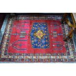 An old Persian Hamadan rug, red ground centred by a multi-coloured lozenge, 202 x 147 cm