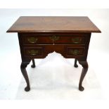 An 18th century cross-banded oak lowboy, the two plank top over an arrangement of three drawers