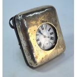 A silver-faced travelling watch stand, London 1913, containing a large electroplated pocket watch