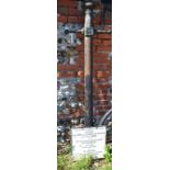 A cast iron lamp post top with attached R B Kingston notice