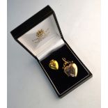 Two heart-shaped lockets, one 15ct set with ruby and diamonds, and one yellow metal with small