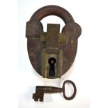 A large antique iron and brass padlock with key