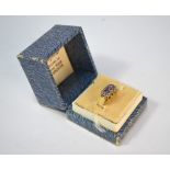 A three-stone tanzanite ring with small eight cut diamonds around, 9ct yellow and white gold