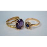An oval sapphire and diamond cluster ring, yellow metal set stamped 18k to/w a synthetic corundum