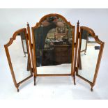 A walnut framed triptych toilet mirror with arched top