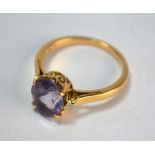 A single stone oval amethyst ring, yellow metal set, stamped 18k, size O 1/2