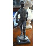 An antique brown bronze sculpture of an officer, 38 cm high overall