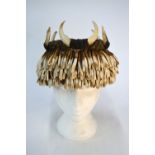 An African tribal headdress with leopard-skin crown and mounted with bone 'wings' embellished with