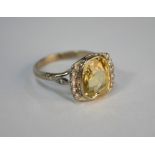 A cushion-shaped pale yellow sapphire and diamond cluster ring, 18ct white gold setting, size N