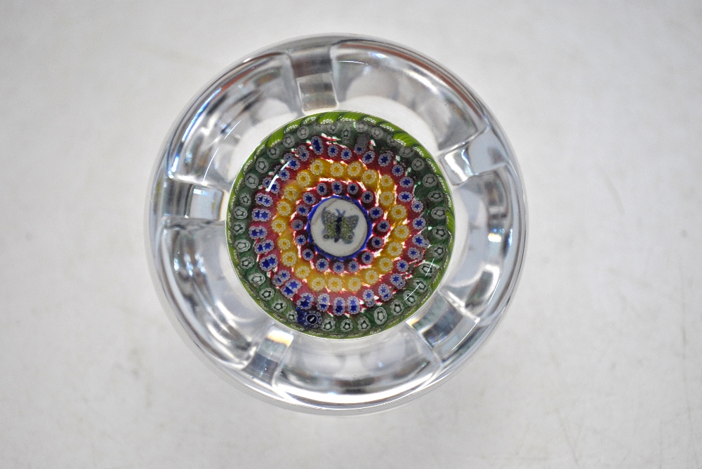 A faceted glass paperweight decorated with a central butterfly cane and concentric bands of canes in - Image 6 of 8