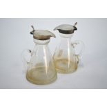 A pair of Edwardian conical glass whisky noggins with star-cut bases and silver collars and