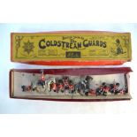 A Britains set, the Coldstream Guards Firing kneeling (box) a/f, to/w two mounted figures