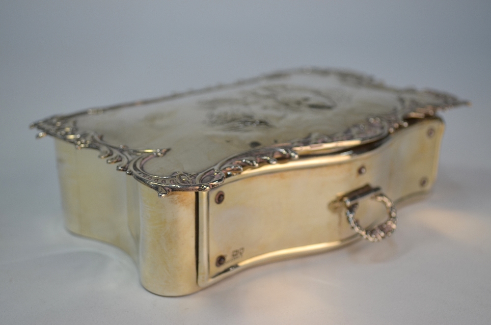 A silver jewellery box of serpentine form, the scroll-edge top embossed with winged cherub-heads, - Image 4 of 7