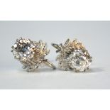 A pair of old cut diamond stud earrings in claw settings with leaf decoration, post stamped 9ct,