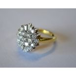 A diamond set marquise shaped cluster ring, having brilliant and tapering cut diamonds, shank