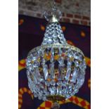 A classic crystal strung gilt metal light fitting, 27 cm diam All complete - not tested
