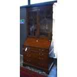 An 18th century oak bureau bookcase, with astragal glazed doors enclosing adjustable shelves over