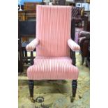 A 19th century upholstered open library armchair with high back and overstuffed arms, raised on