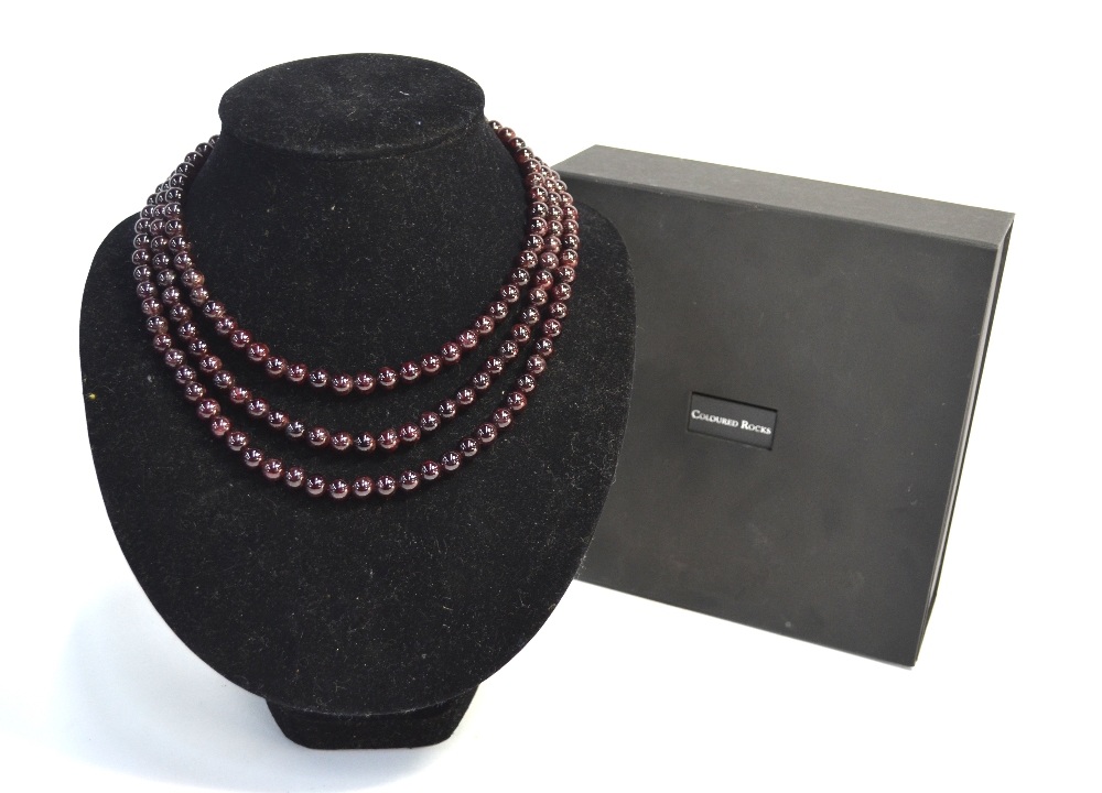 A triple row garnet bead necklace within fitted box