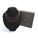 A triple row garnet bead necklace within fitted box