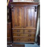 A Victorian figured mahogany linen press with a pair of panelled doors enclosing fitted slides