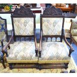 A pair of antique oversize 17th century style oak framed open armchairs with overstuffed seats (2)