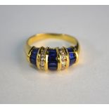 A sapphire and diamond bombe style ring, set baguette sapphires and brilliant cut diamonds, in