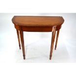 A Sheraton style cross-banded satinwood side table, raised on shaped tapering legs