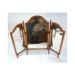 A walnut framed triptych toilet mirror with arched top