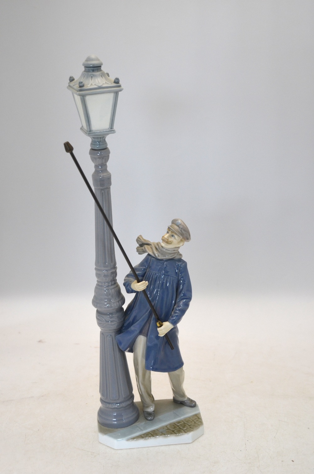 A Lladro model of a gas lamp lighter, 47 cm high Thumb missing on right hand