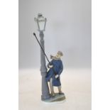 A Lladro model of a gas lamp lighter, 47 cm high Thumb missing on right hand