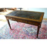 A late 19th/20th century writing table with tooled leather top over three frieze drawers with