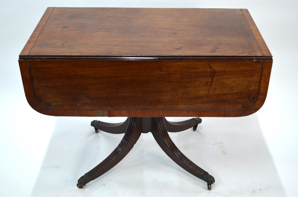 A Victorian cross-banded mahogany table with drop leaf top over a frieze drawer to end, raised on