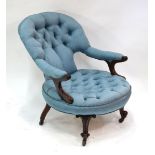 A late 19th century walnut framed open armchair with buttoned blue water silk upholstery, raised