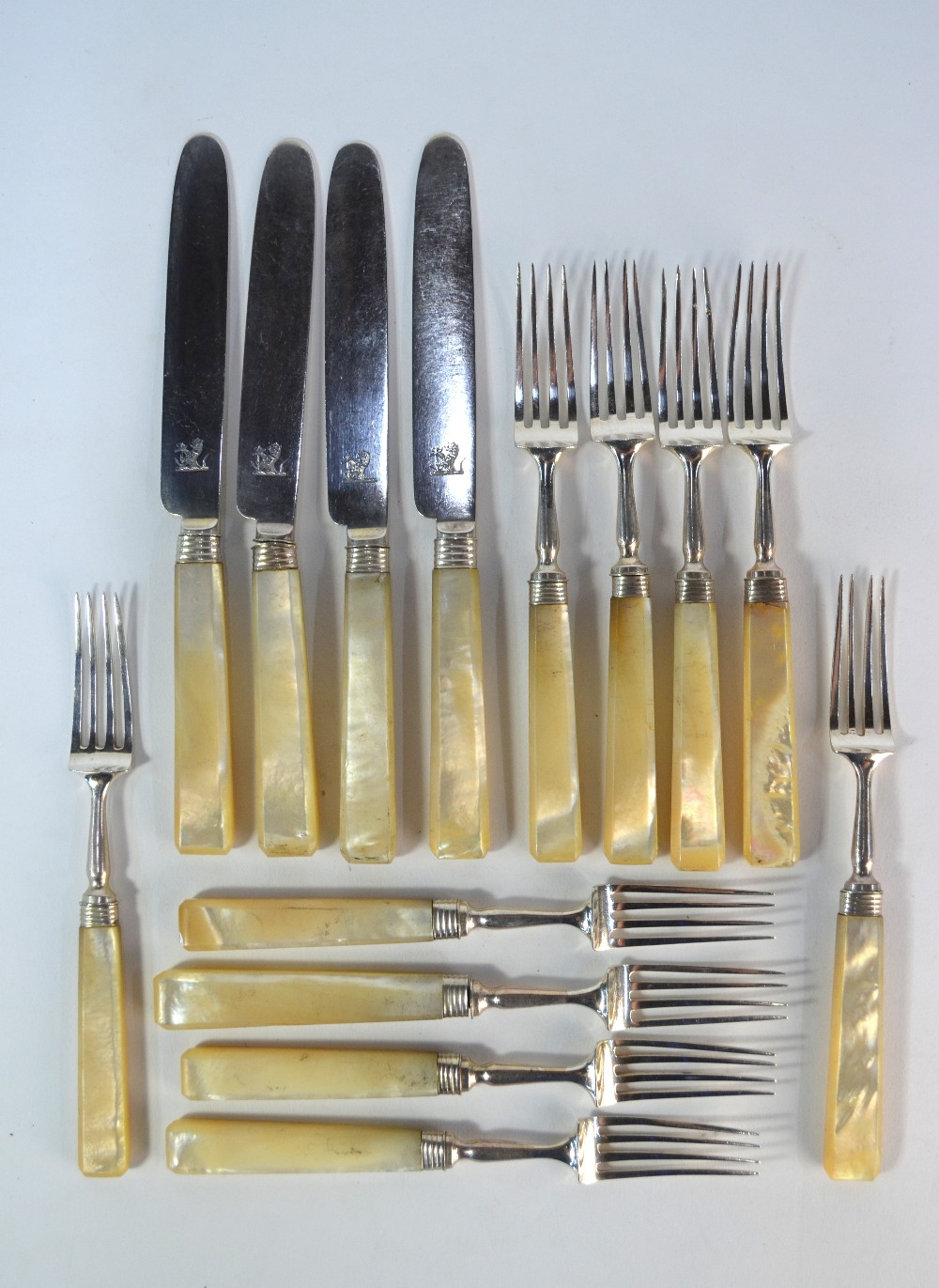 A George IV silver part-set of six dessert forks with four matching knives, with mother-of-pearl