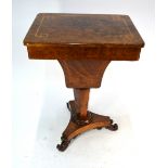 A Victorian figured walnut work table with fitted interior over a shaped storage well, raised on a