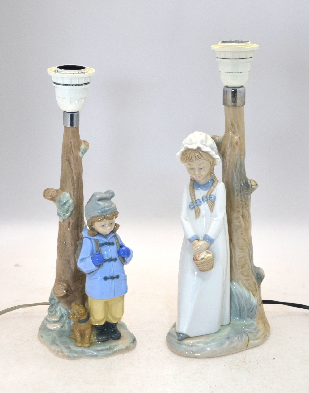 Two Nao lamp bases - one with a girl holding a basket, 30 cm high, the other with a boy in a