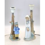 Two Nao lamp bases - one with a girl holding a basket, 30 cm high, the other with a boy in a