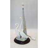 A Nao lamp base modelled with two mute swans c/w separate wooden base, 45 cm high excluding light