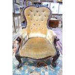 A Victorian moulded show-framed spoonback button upholstered armchair