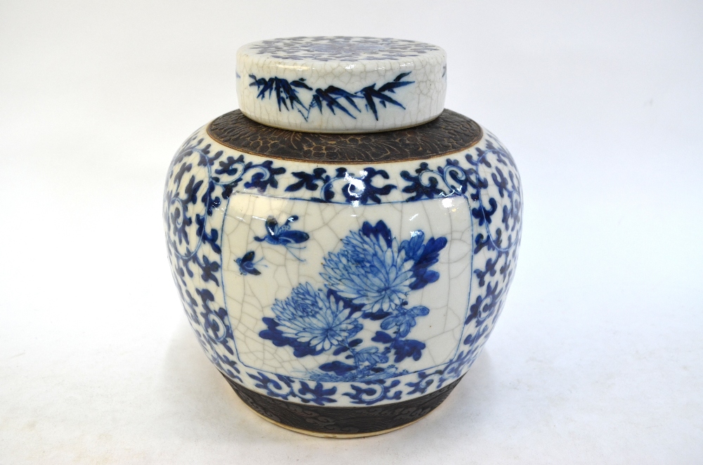 A large underglaze blue decorated Chinese vase with cylindrical cover; decorated with a Scholar