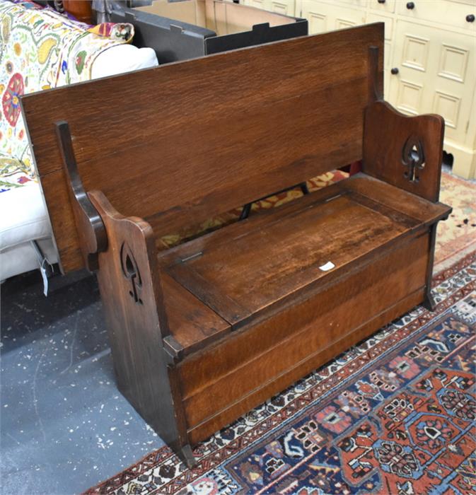 An Arts and Crafts period monks bench, the top hinging over to form a seatback, over a box seat with - Image 2 of 6