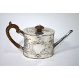 A George III silver tea pot of oval cylindrical form with straight tapering spout and rococo style