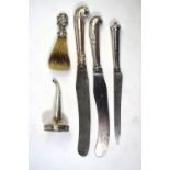 Three silver-handled knives with steel blades, to/w a wine funnel spout by Hester Bateman and a