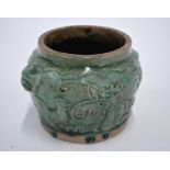 A Vietnamese, or other Asian, green glazed stoneware vase, decorated in high relief with the unusual