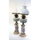 A pair of Dresden oil lamps, 19th century, the oil well moulded with Neptune, Salacia, dolphins