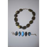 A large labradorite necklace formed of polished stones with small white metal spacers between, on