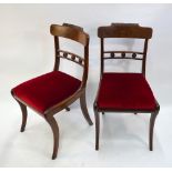 A set of six Regency figured mahogany dining side chairs with moulded rests to the bar backs over